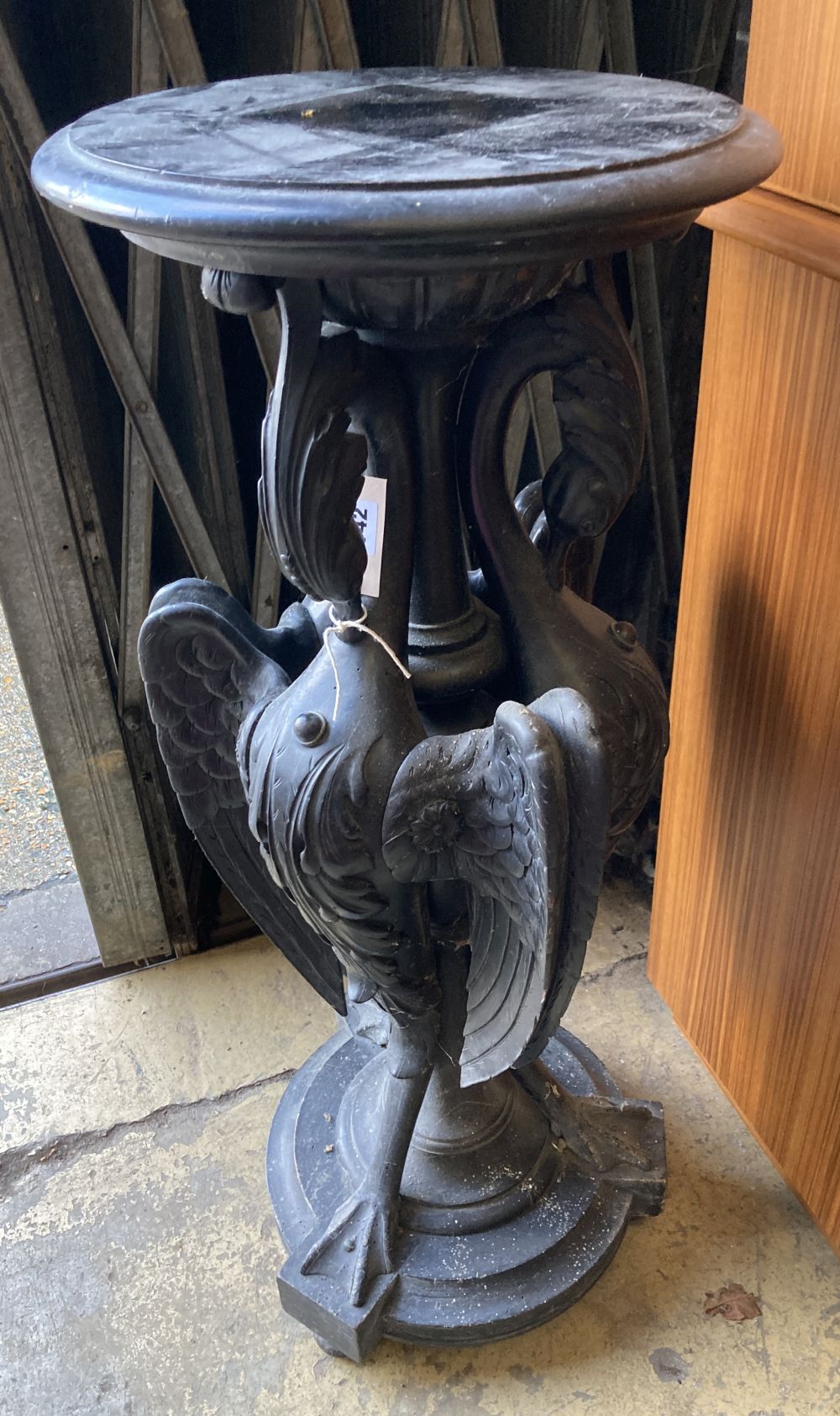 A Victorian ebonised carved wood lamp table in the form of three monopodiae stylised birds, 38cm diameter, height 94cm